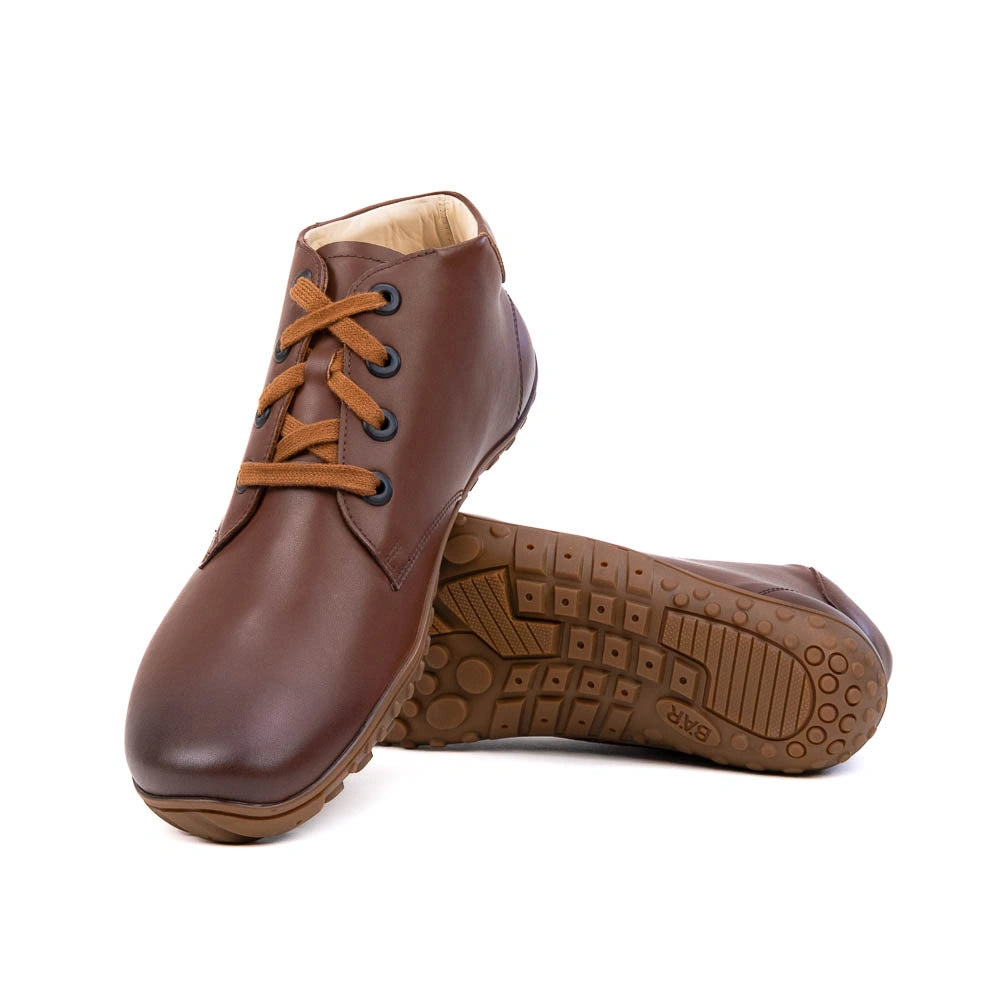Brown leather shoes with brown laces on a white background