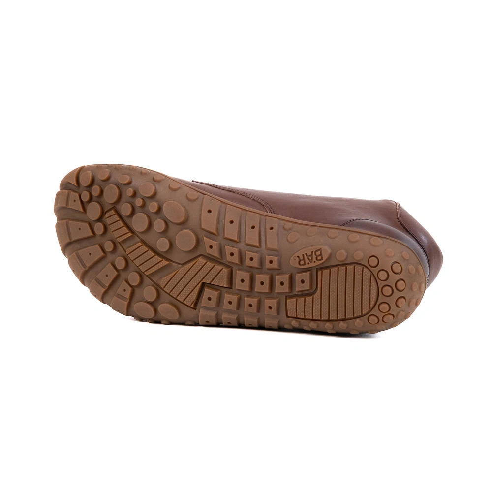 Brown shoe sole with visible brand logo on a white background