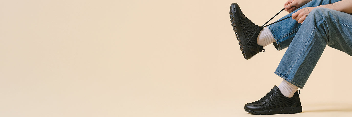 Person trying black wide toe walking shoes Baer