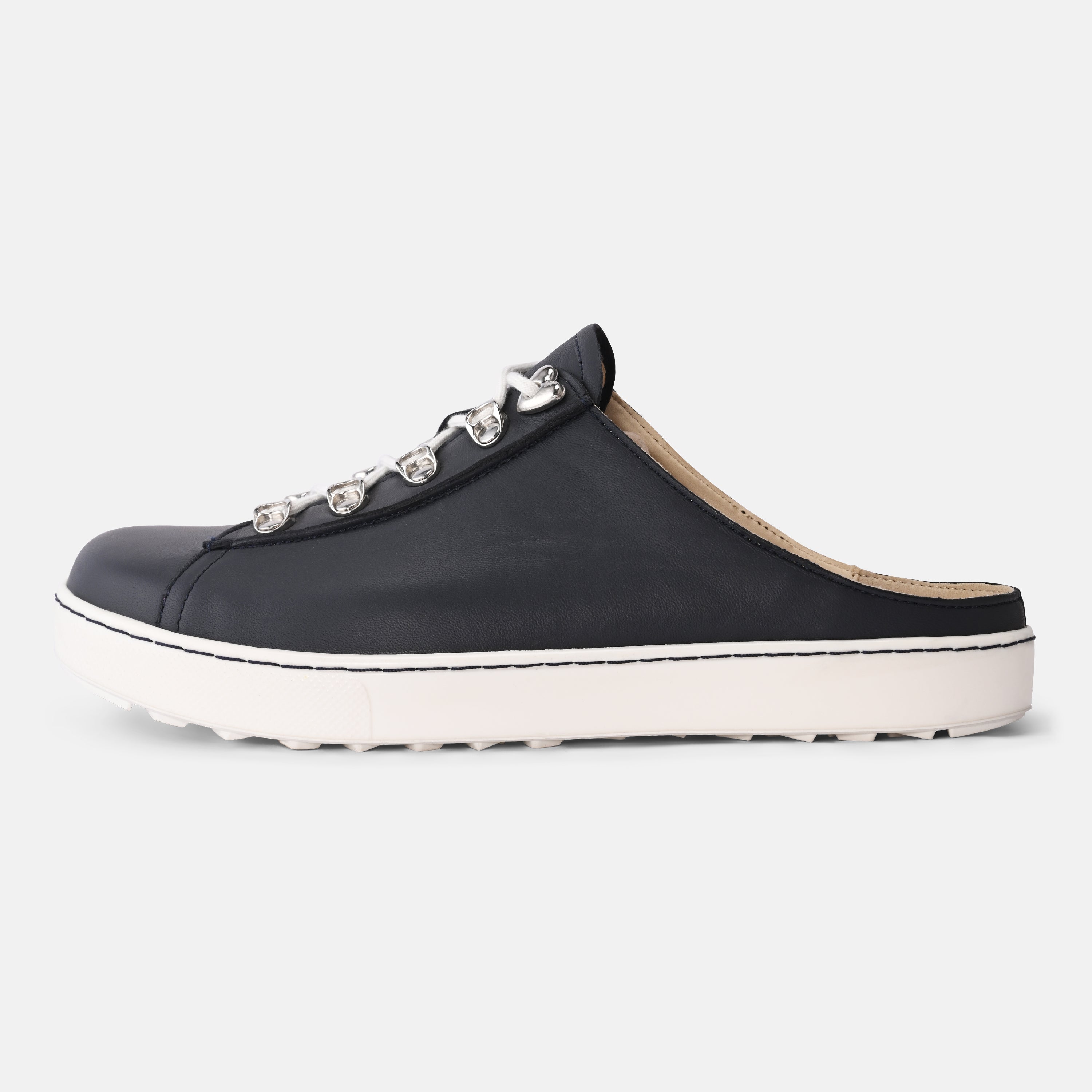 Black slip-on shoe with decorative elements on a white background