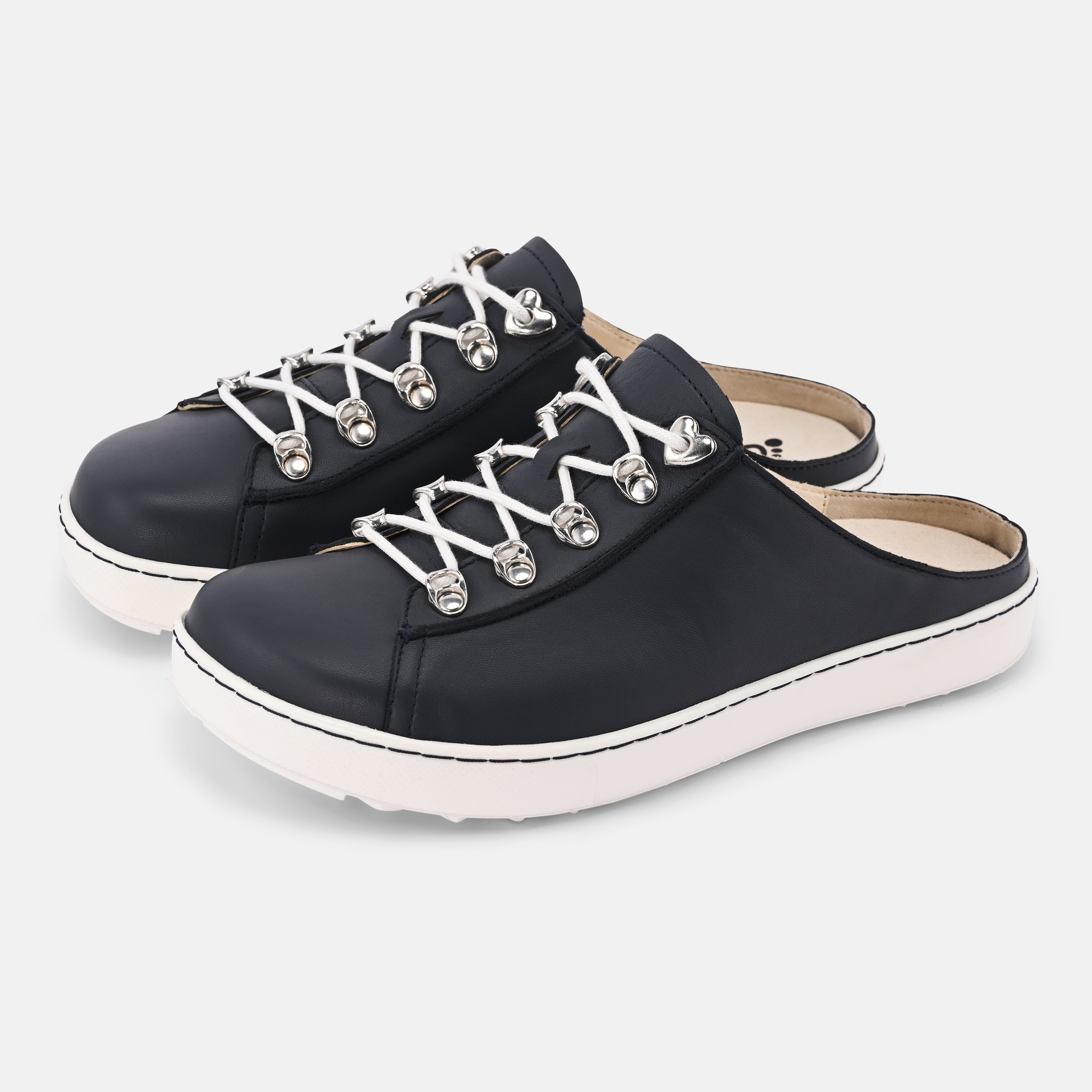 Black slip-on shoes with white soles on a light gray background