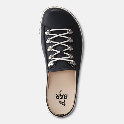 Black sneaker with white laces on a light gray background